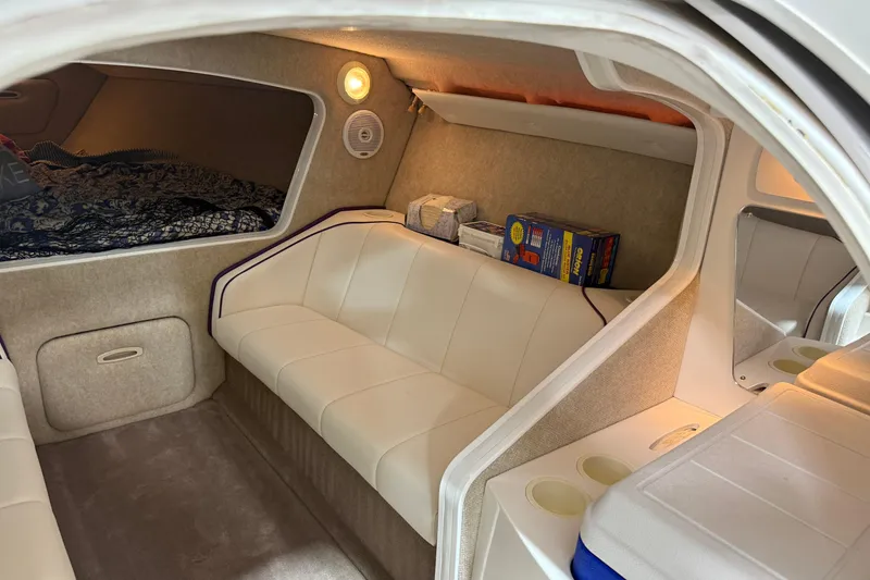 Slide: The Image of Interior of a 2002 Nordic Boats 28' Heat, featuring cozy seating and storage. - 25