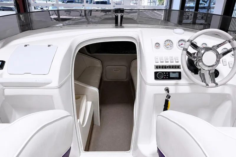 Slide: The Image of 2002 Nordic Boats 28' Heat interior with sleek dashboard and modern steering wheel design. - 23