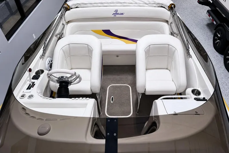 Slide: The Image of 2002 Nordic Boats 28' Heat interior with white seating and modern steering console. - 11