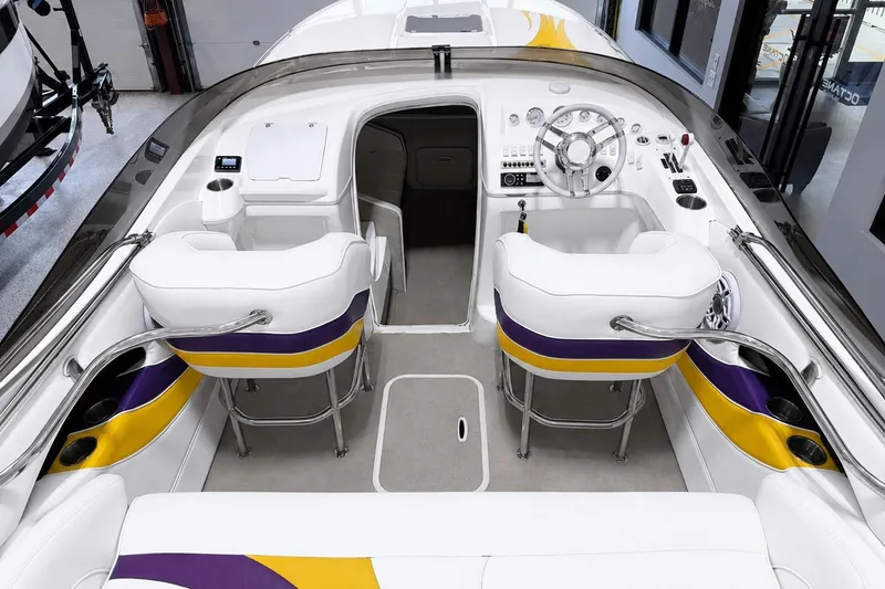 Slide: The Image of 2002 Nordic Boats 28' Heat interior with white, purple, and yellow seating, sleek dashboard. - 19