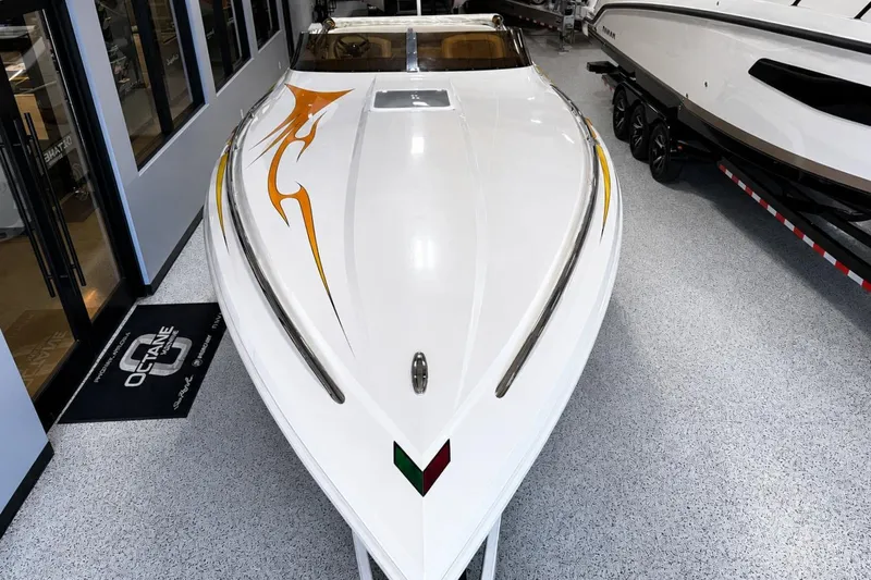 Slide: The Image of 2002 Nordic Boats 28' Heat, sleek white design with orange graphics, displayed indoors. - 9