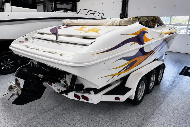 Slide: The Image of 2002 Nordic Boats 28' Heat with vibrant flame graphics on a triple-axle trailer. - 7