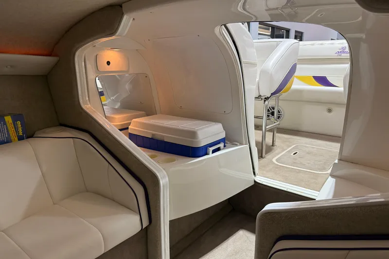 Slide: The Image of Interior of a 2002 Nordic Boats 28' Heat, featuring seating and a cooler. - 28