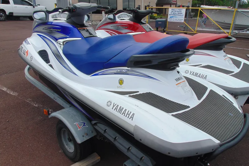 Slide: The Image of 2006 Yamaha WaveRunner FX Cruiser with blue seat on a trailer, parked outdoors. - 2