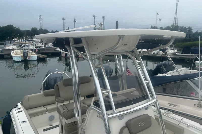 Slide: The Image of 2024 Key West 219 FS boat docked at marina, featuring sleek design and modern amenities. - 2