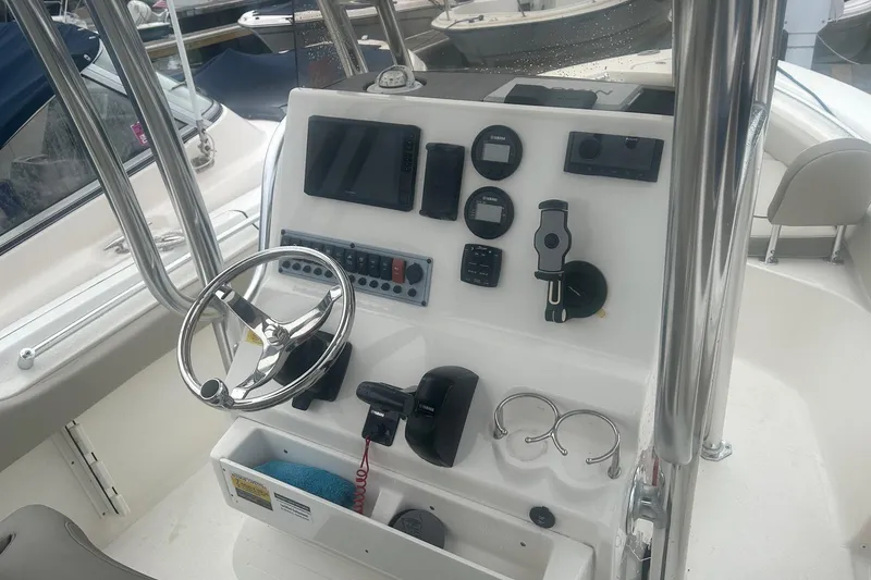 Slide: The Image of 2024 Key West 219 FS boat dashboard with steering wheel and navigation controls. - 10