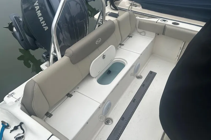 Slide: The Image of 2024 Key West 219 FS boat interior with Yamaha engine, featuring seating and storage compartments. - 6
