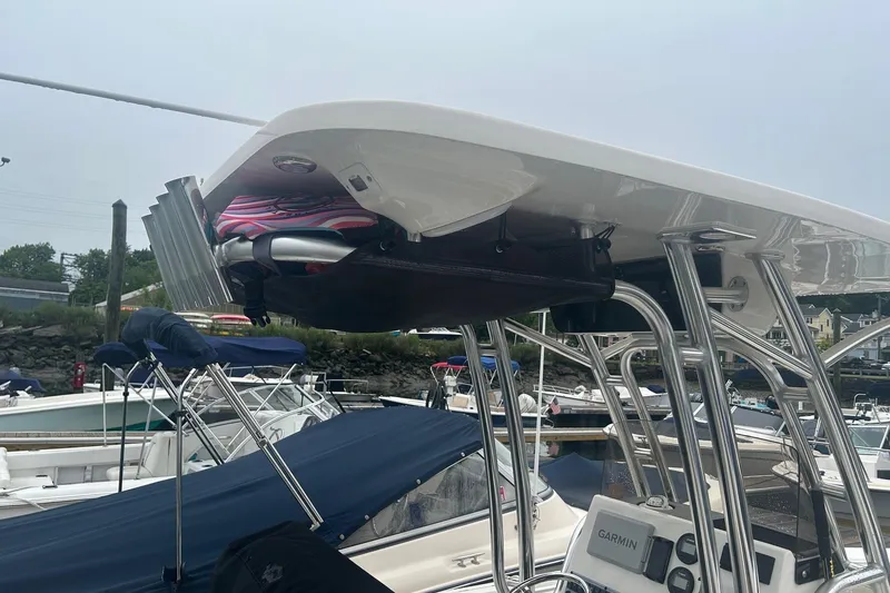 Slide: The Image of 2024 Key West 219 FS boat with T-top and Garmin electronics at marina. - 15
