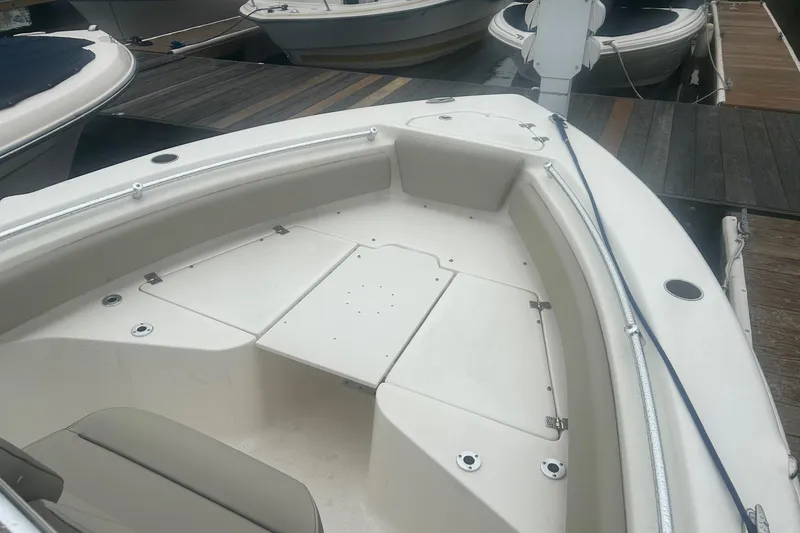 Slide: The Image of 2024 Key West 219 FS boat interior at dock, featuring spacious seating and storage. - 13
