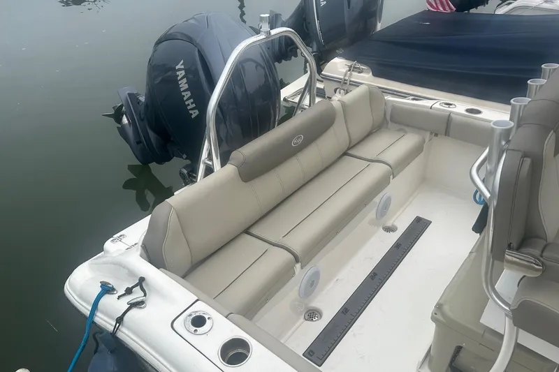 Slide: The Image of 2024 Key West 219 FS boat interior with Yamaha engine, featuring beige seating. - 8