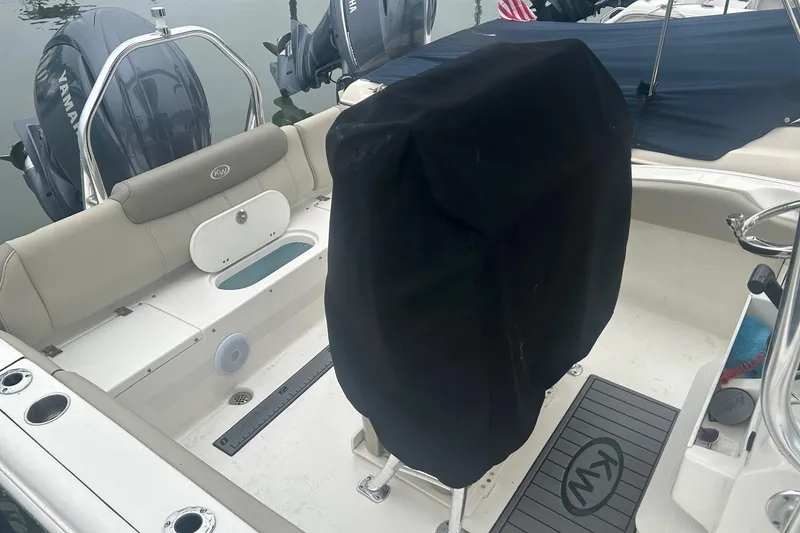 Slide: The Image of 2024 Key West 219 FS boat interior with covered seat and Yamaha engines. - 7