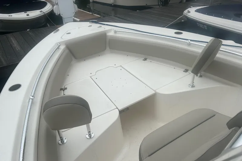 Slide: The Image of 2024 Key West 219 FS boat interior with seating and storage compartments. - 12