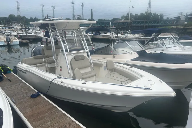 The Image of 2024 Key West 219 FS boat docked at a marina, surrounded by other vessels. - 0