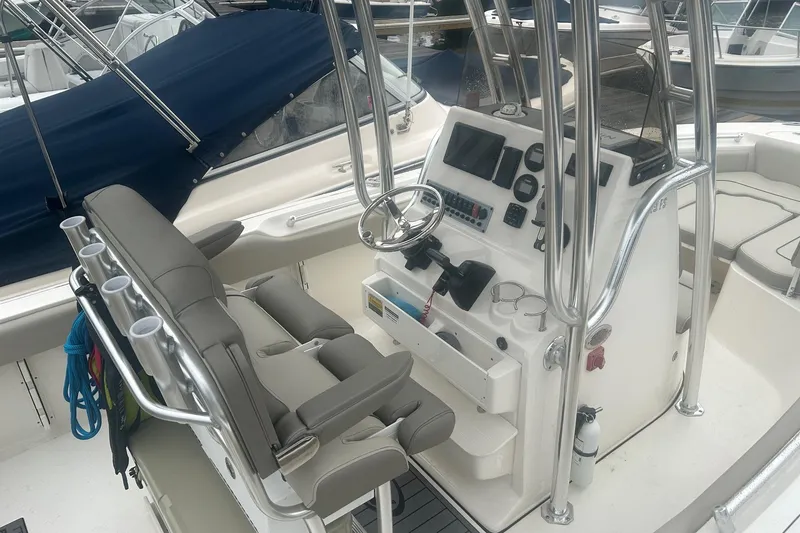 Slide: The Image of 2024 Key West 219 FS boat interior with steering console and seating. - 11