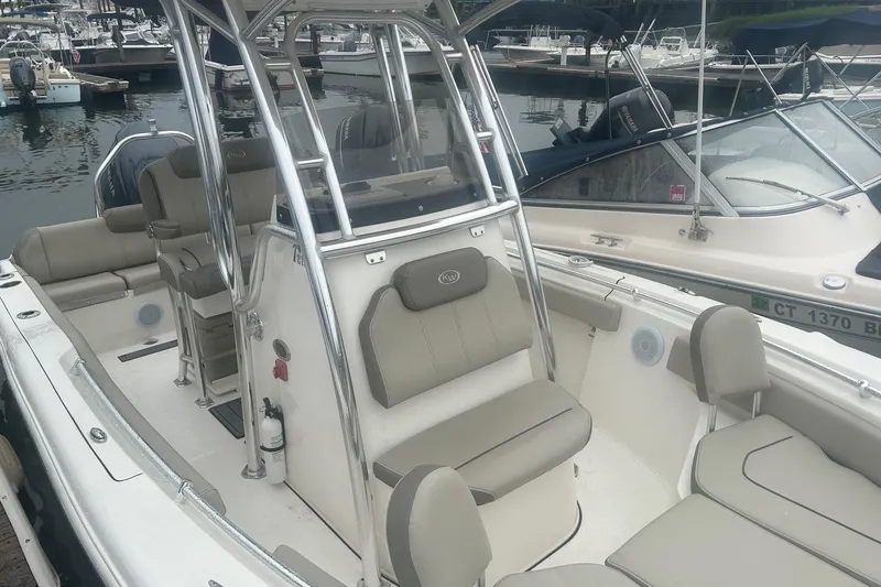 Slide: The Image of 2024 Key West 219 FS boat with beige seating, docked in a marina. - 4