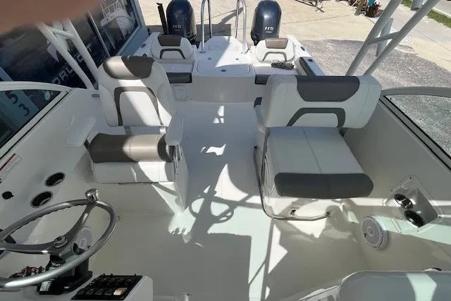 Slide: The Image of 2019 World Cat 230 DC boat interior with seating and dual engines. - 6