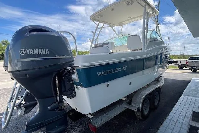 Slide: The Image of 2019 World Cat 230 DC boat on trailer with Yamaha outboard motor, parked outdoors. - 3
