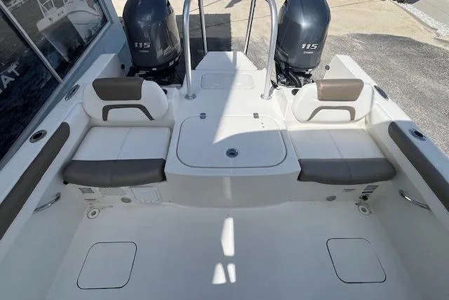 Slide: The Image of 2019 World Cat 230 DC boat interior with dual 115 engines, spacious seating, and storage compartments. - 7