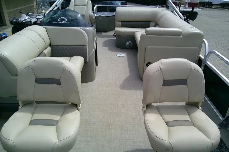 Slide: The Image of 2023 Sun Tracker Fishin' Barge 20 DLX interior with beige seating and spacious layout. - 6