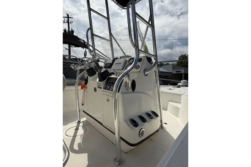 Slide: The Image of 2003 Triton 220 LTS boat console with steering wheel and navigation equipment. - 5