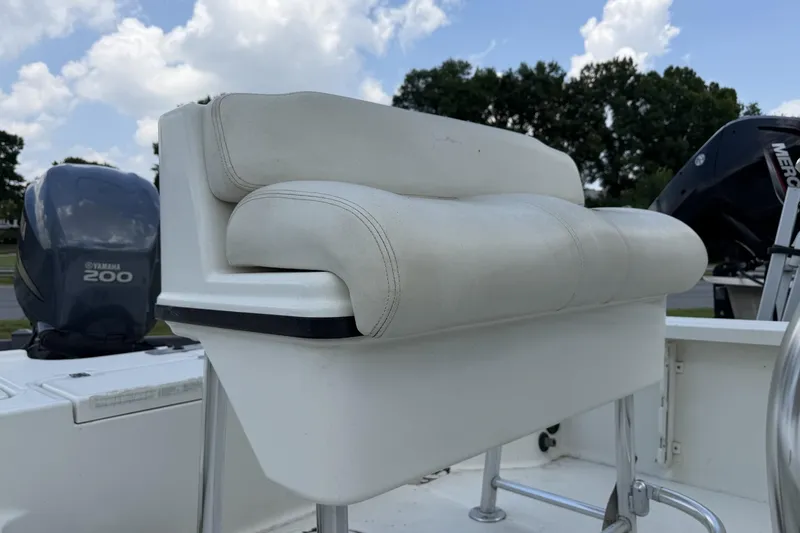 Slide: The Image of 2003 Triton 220 LTS boat seat with Yamaha 200 engine in background. - 7