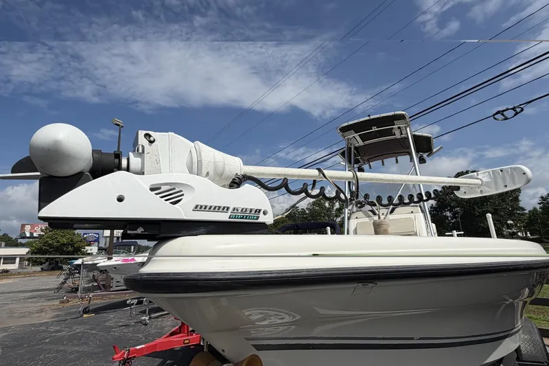 Slide: The Image of 2003 Triton 220 LTS boat with Minn Kota trolling motor under a clear sky. - 3