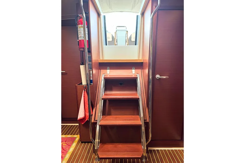 Slide: The Image of Interior stairs of 2020 Hanse 458 yacht with wooden finish and safety equipment. - 17