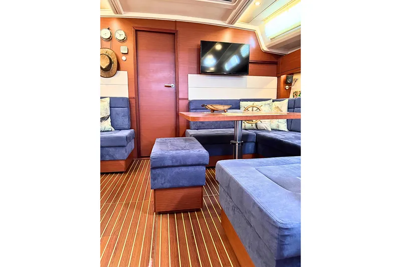 Slide: The Image of Luxurious interior of 2020 Hanse 458 yacht with blue seating and wooden accents. - 19