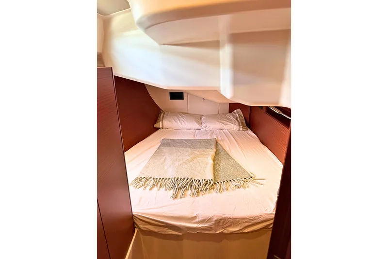 Slide: The Image of Cozy cabin interior of 2020 Hanse 458 yacht with neatly arranged bedding. - 23