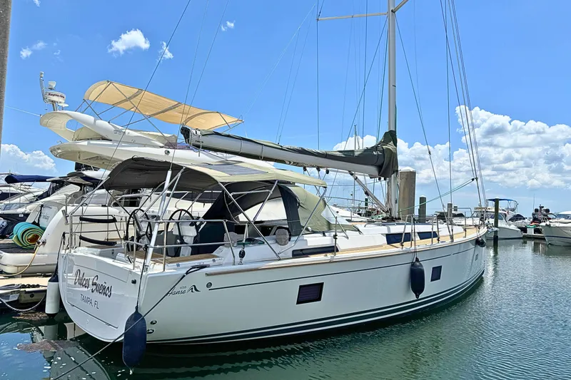The Image of 2020 Hanse 458 yacht docked in marina under clear blue sky. - 0