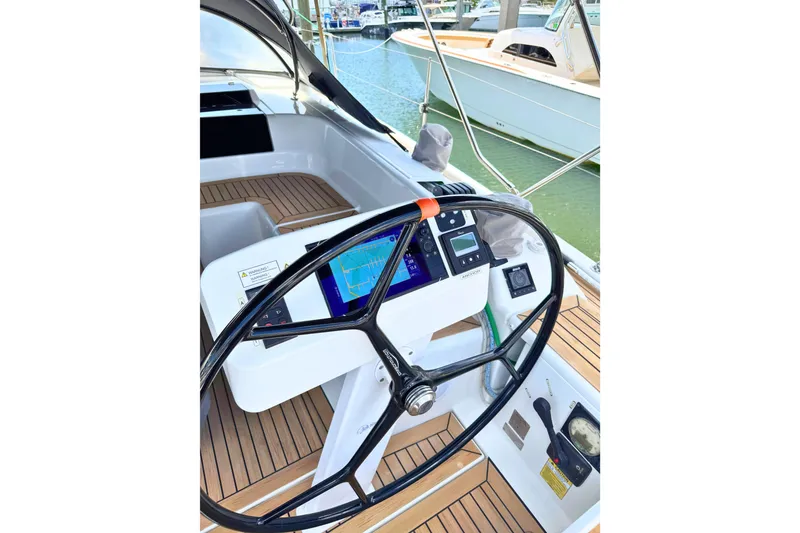 Slide: The Image of Steering wheel and navigation system of 2020 Hanse 458 yacht in marina. - 3