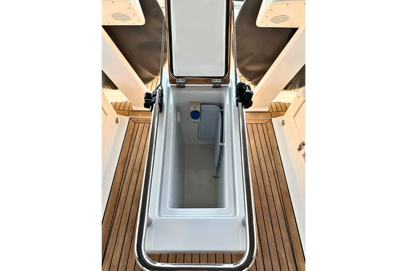 Slide: The Image of Open storage compartment on 2020 Hanse 458 yacht with teak flooring. - 11