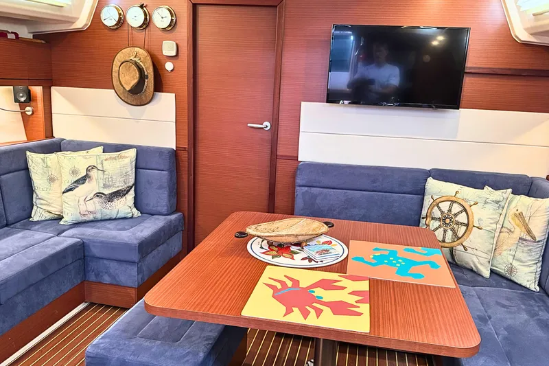 Slide: The Image of Interior of 2020 Hanse 458 yacht with cozy seating, nautical decor, and a mounted TV. - 15