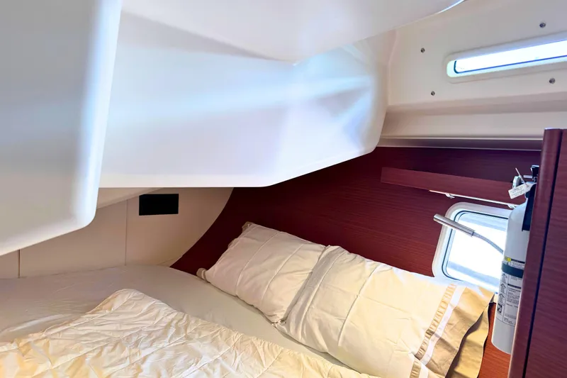 Slide: The Image of Cozy cabin interior of 2020 Hanse 458 yacht with bed and window. - 24