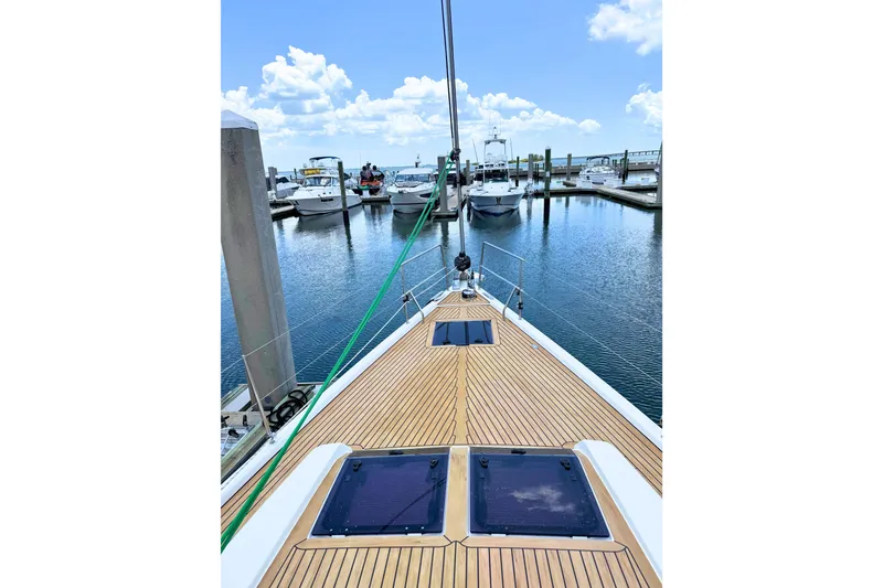 Slide: The Image of Bow view of 2020 Hanse 458 yacht docked at marina under blue sky. - 2