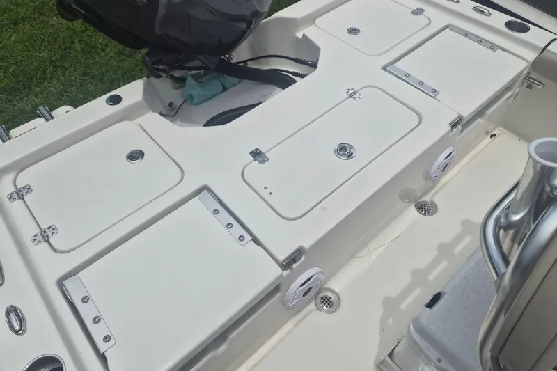 Slide: The Image of 2026 Key West 210 Bay Reef boat deck with storage compartments and motor. - 6