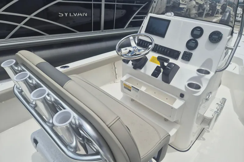Slide: The Image of 2026 Key West 210 Bay Reef boat console with steering wheel and controls. - 8