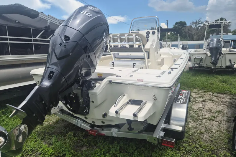 Slide: The Image of 2026 Key West 210 Bay Reef boat with powerful outboard motor on trailer. - 3