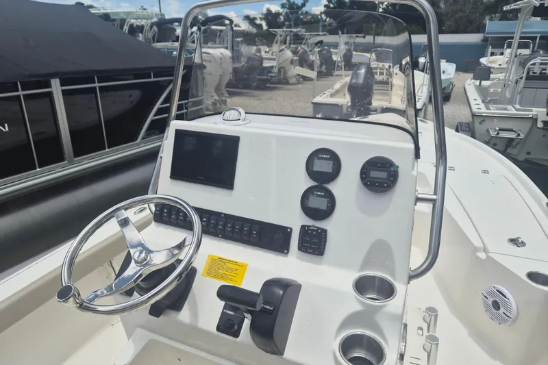 Slide: The Image of 2026 Key West 210 Bay Reef boat dashboard with steering wheel and control panel. - 10