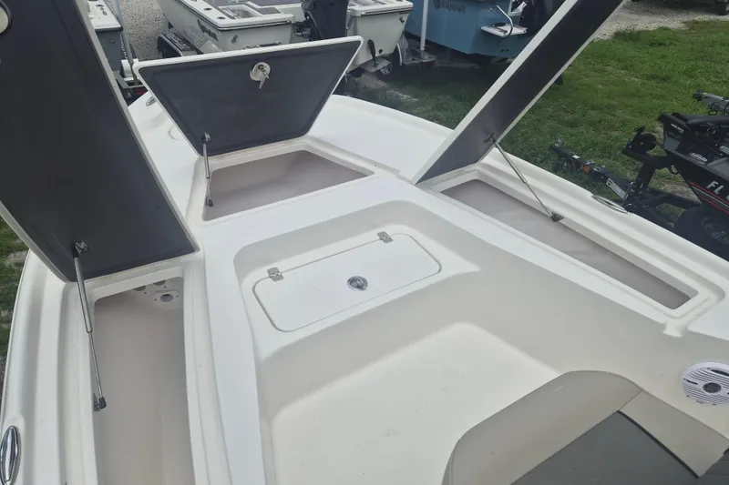 Slide: The Image of 2026 Key West 210 Bay Reef boat deck with open storage compartments. - 17