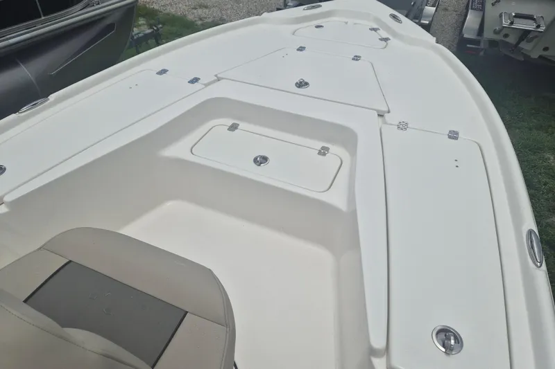 Slide: The Image of 2026 Key West 210 Bay Reef boat deck with storage compartments and seating. - 13