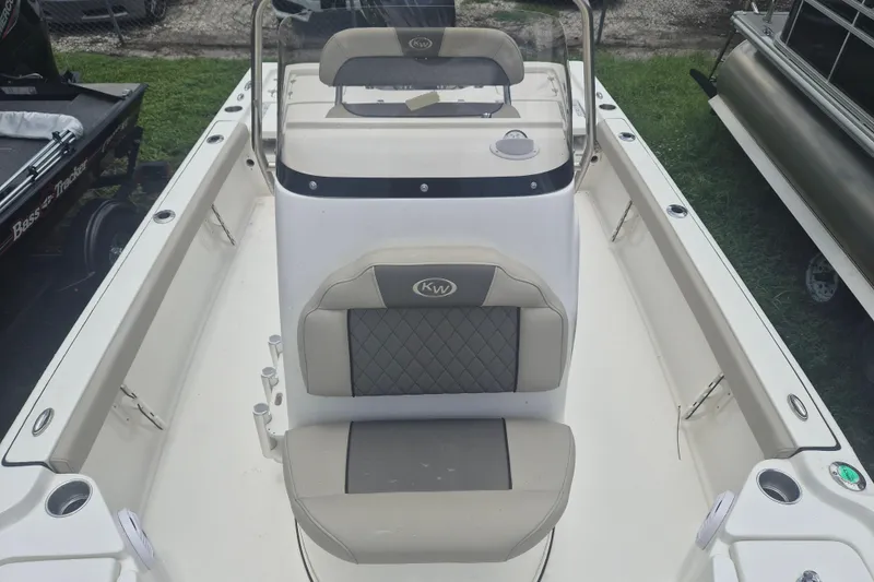 Slide: The Image of 2026 Key West 210 Bay Reef boat interior with cushioned seating and steering console. - 14