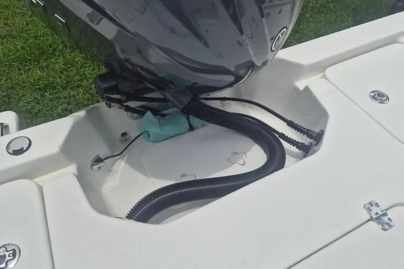 Slide: The Image of 2026 Key West 210 Bay Reef boat engine compartment with cables and hoses. - 7