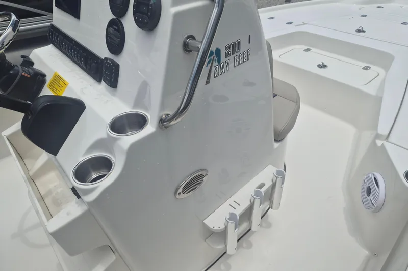 Slide: The Image of 2026 Key West 210 Bay Reef boat console with cup holders and control panel. - 12
