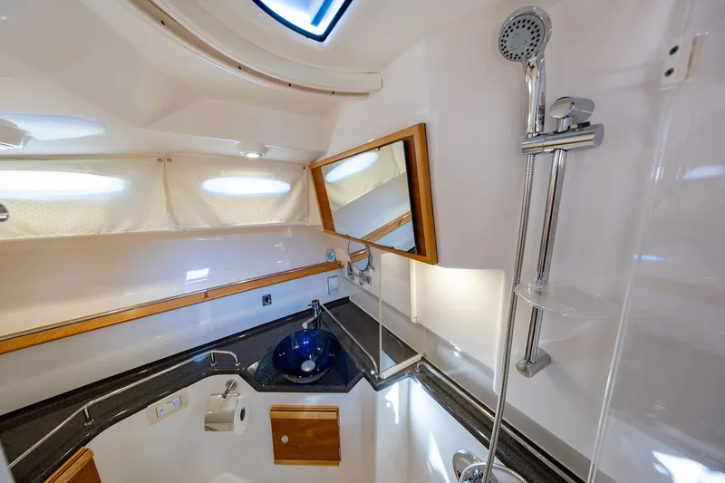 Slide: The Image of Modern bathroom interior of 2021 Cutwater C-32 Coupe yacht with sleek fixtures and blue sink. - 22