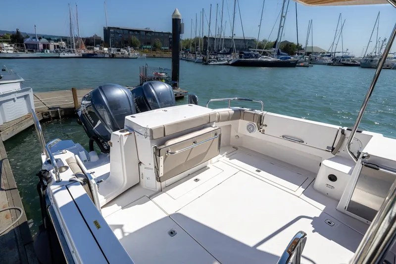 Slide: The Image of 2021 Cutwater C-32 Coupe boat docked at marina with twin engines. - 5