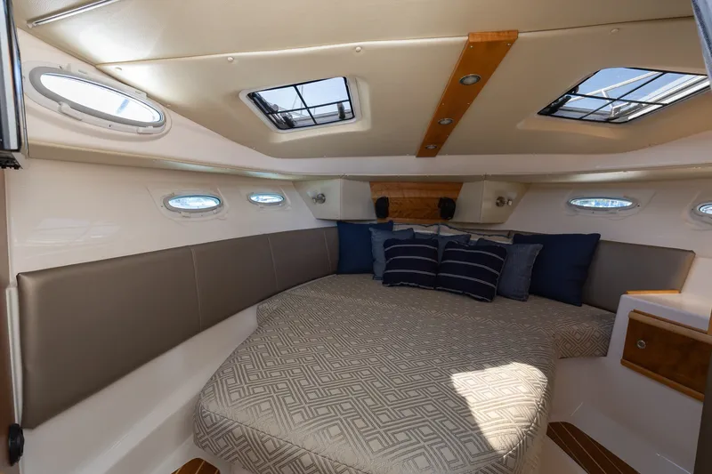 Slide: The Image of Interior of 2021 Cutwater C-32 Coupe with cozy bed and stylish decor. - 19