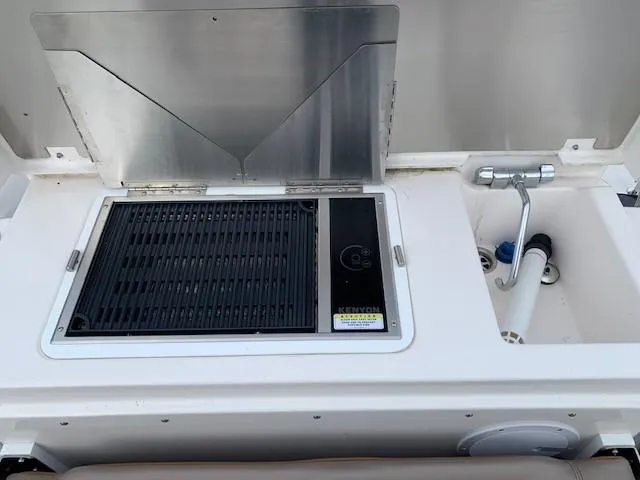 Slide: The Image of The 2021 Cutwater C-32 Coupe features an outdoor kitchen with a grill and sink. - 9