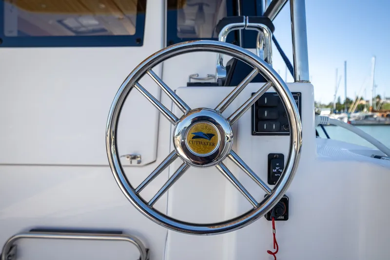 Slide: The Image of Steering wheel of 2021 Cutwater C-32 Coupe boat, docked at marina. - 11