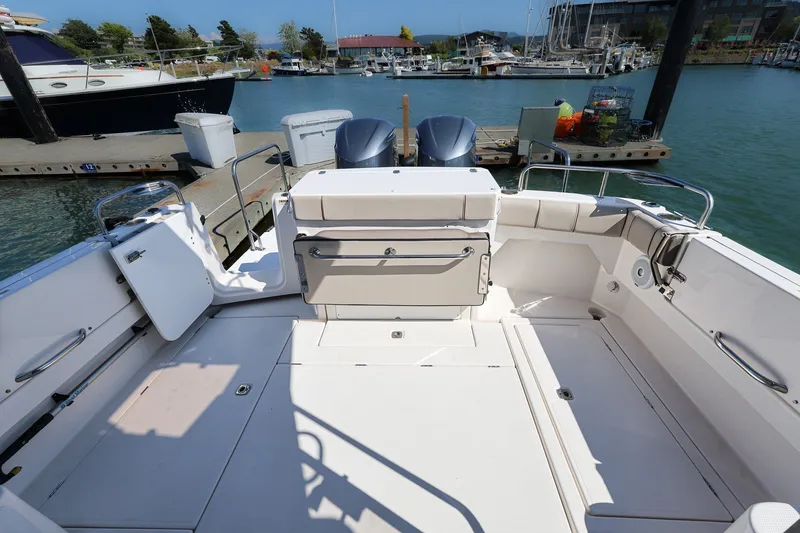 Slide: The Image of 2021 Cutwater C-32 Coupe boat cockpit with seating, docked at marina. - 4